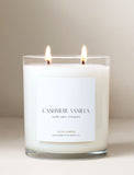 Lit candle with white label. - Image 