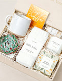 Forever Remembered gift box containing a ceramic mug, succulent, fluffy white socks, herbal tea, matches, and a candle. - Image 