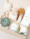 Lula's Garden gift box featuring a succulent, vanilla candle, silk sleep mask, scrunchie, matches, brush, and fluffy socks. - Image 