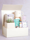 Gift box filled with wellness items. - Image 