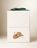 Beige gift box with an imprint and green bow. - Image 