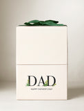 Cream-colored gift box for Father's Day featuring DAD text with succulent accents and a dark green ribbon bow on top. - Image 