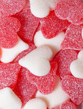 A pile of red and white heart-shaped gummy candies coated in sparkling sugar crystals. - Image 