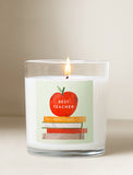 Candle with illustration of apple and books on the candle label. - Image 