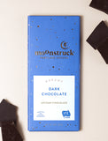 Blue chocolate bar with chocolate next to it. - Image 