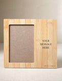 Personalized light bamboo picture frame with a vertical photo slot and space for custom text engraving. - Image 