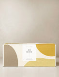 Gift bow in a yellow and brown gift wrap. - Image 