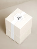 Beige gift box with white bow and occasion tag. - Image 