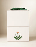 Beige gift box with an imprint and green bow. - Image 