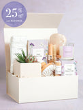 Mother's Day gift box featuring a succulent, fluffy socks, a scented candle, wooden brushes, and matches in a cream box. - Image 