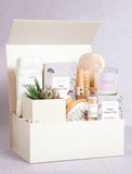 Beige gift box filled with wellness items. - Image 