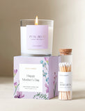 Candle on top of gift box next to matches. - Image 