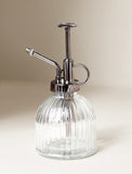 Glass mister in front of beige background. - Image 