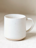 Ceramic mug on beige table. - Image 