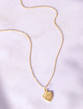 Gold necklace on purple background. - Image 