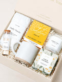 Forever Remembered gift box with white mug, fluffy socks, herbal tea, matches, and a scented candle in a cream box. - Image 