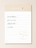 Beige and white notepad. - Image 