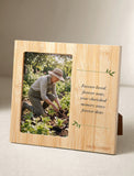 Bamboo keepsake photo frame with a sympathy quote and a picture of a woman gardening in a sunlit outdoor setting. - Image 