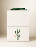 Beige gift box with an imprint and green bow. - Image 