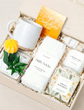 Sympathy gift box with a ceramic mug, fluffy white socks, a cactus, a candle, matches, and herbal tea in a neutral box. - Image 