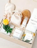 Lula's Garden gift box featuring a yellow cactus, cashmere vanilla candle, silk sleep mask, fluffy socks, and matches. - Image 
