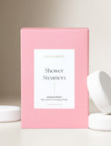 Shower steamers next to a pink gift box. - Image 
