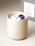 Candle next to gift box. - Image 
